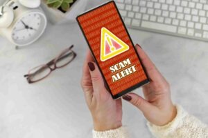 scam alert on cell phone personal cybersecurity concept