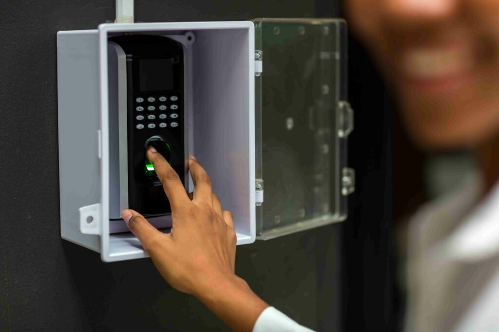 person touching a fingerprint scanner